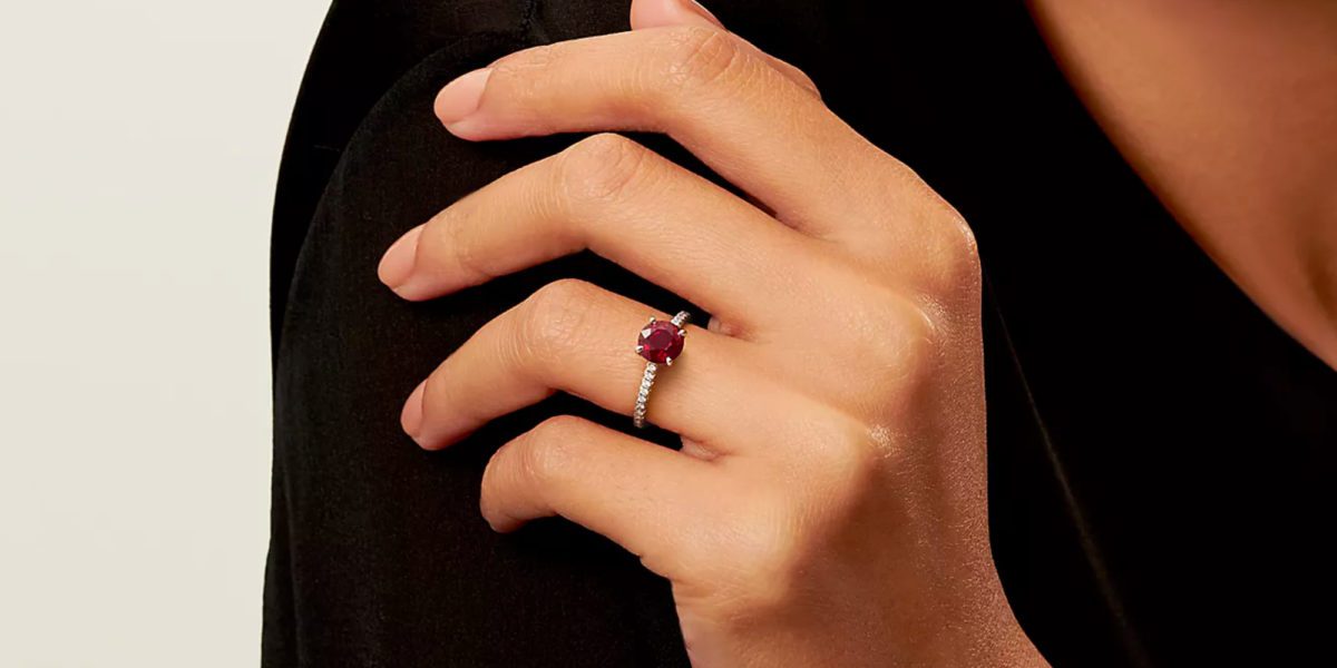 a close up of a Tiffany Novo Ruby ring on a table.