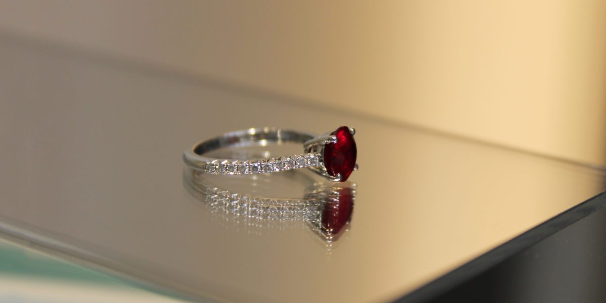 a close up of a Tiffany Novo Ruby ring on a table.