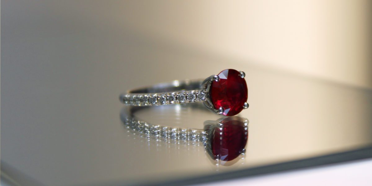 a close up of a Tiffany Novo Ruby ring on a table.